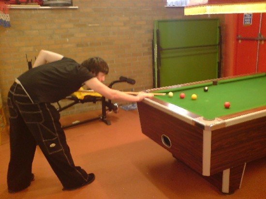 Youngster playing pool